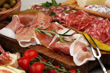 Italian antipasti wine snacks set. Cheese variety, Mediterranean olives, pickles, Prosciutto di Parma and salami