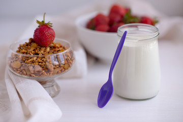Homemade granola in jar on rustic kitchen table, healthy breakfa