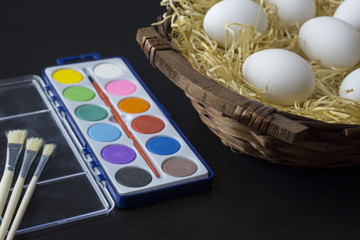 Eggs in a basket and a paintbox