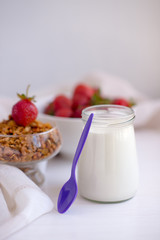 Homemade granola in jar on rustic kitchen table, healthy breakfa