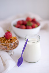 Homemade granola in jar on rustic kitchen table, healthy breakfa