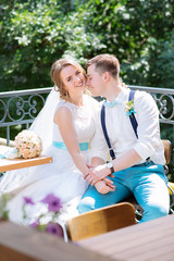 the bride and groom pose for the camera