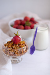 Homemade granola in jar on rustic kitchen table, healthy breakfa