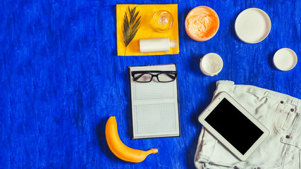 template. notepad, glasses, tablet, cream, blue background. banana. seashells. summer set