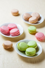 Colourful macaroons on the plates