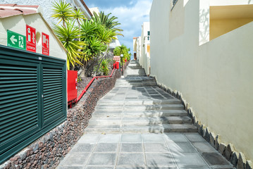 Fototapeta na wymiar Stairs between tropical apartments