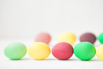 Fototapeta na wymiar Colorful Easter eggs on white wooden background.