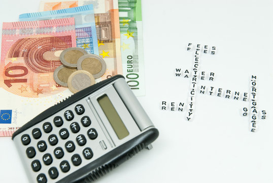 euro and calculator and words representing household monthly expenses concept photo 