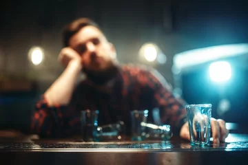 Fotobehang Bar Drunk man sleeps at bar counter, alcohol addiction