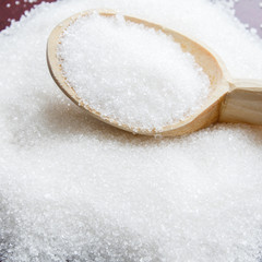 Sugar on wooden table. Selective focus