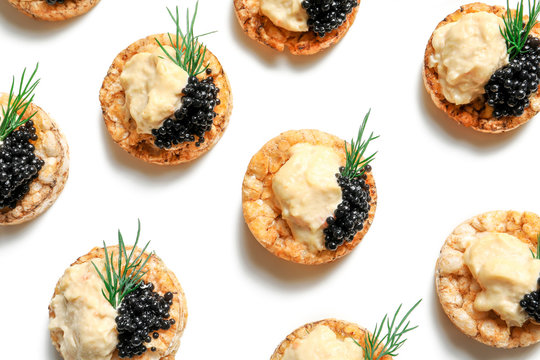Tasty black caviar appetizer on white background