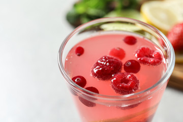 Glass of fresh lemonade with berries, closeup