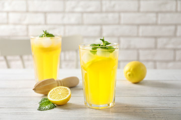 Glasses of fresh lemonade on table