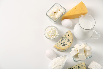 Different dairy products and eggs on white background