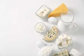 Different dairy products and eggs on white background
