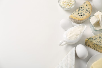 Fototapeta na wymiar Different dairy products and eggs on white background
