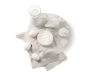 Different dairy products and eggs on white background