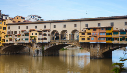 Fototapeta na wymiar View of medieval stone bridge Ponte Vecchio and the Arno River from the Ponte Santa Trinita (Holy Trinity Bridge) in Florence, Tuscany, Italy. Florence is a popular tourist destination of Europe.