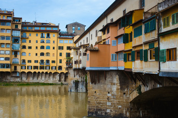 Fototapeta na wymiar View of medieval stone bridge Ponte Vecchio and the Arno River from the Ponte Santa Trinita (Holy Trinity Bridge) in Florence, Tuscany, Italy. Florence is a popular tourist destination of Europe.