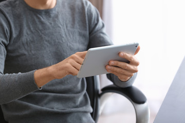 Man using tablet computer indoors