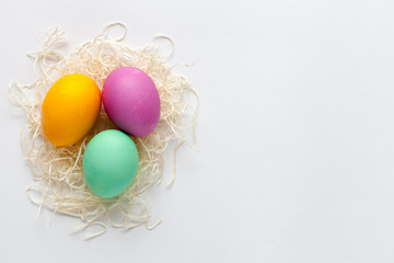Fototapeta na wymiar White easter background with color eggs