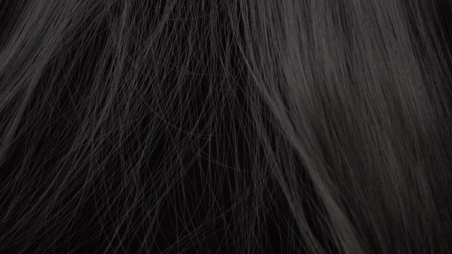 Hair texture background, no person. Black shiny hair Hands touching it