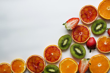 Horizontally background with kiwi, orange, strawberry, tangerine and place for text