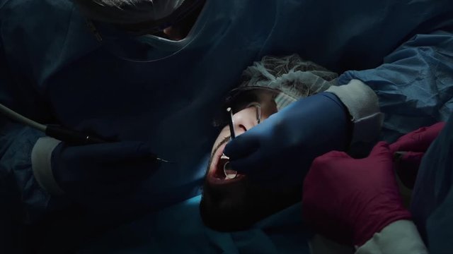 Dentists with a patient during a dental intervention to boy. Dentist Concept