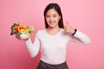 Healthy Asian woman thumbs up with salad.