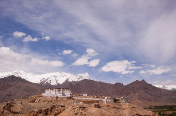 Scenic view on ancient buddhist monastery in himalayas with snowy mountains background. Region Ladakh. India. State Jammu and Kashmir.