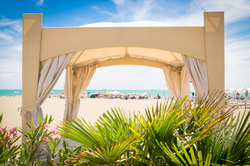 Tropical garden with gazebo on the beach.
