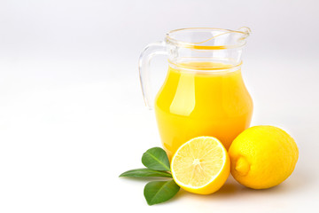 Obraz na płótnie Canvas Fresh orange juice and citrus fruits lime lemon grapefruit in a jar white background healthy concept