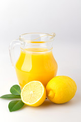 Fresh orange juice and citrus fruits lime lemon grapefruit in a jar white background healthy concept