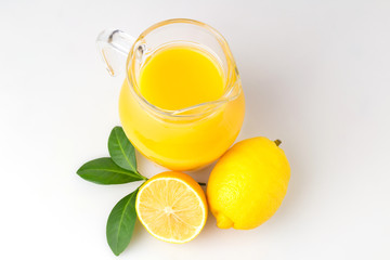 Fresh orange juice and citrus fruits lime lemon grapefruit in a jar white background healthy concept