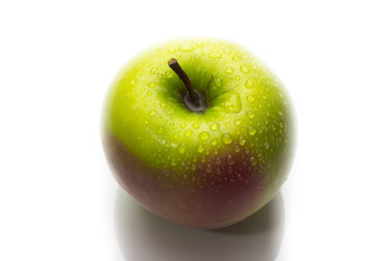 A red and green apple with water drops isolated on a white background.