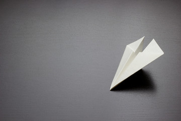 paper air plane on dark background for design