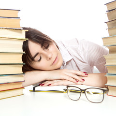 Brunette caucasian woman study, reading books, sitting in front of a desk, wearing glassess. She tired, sleeping