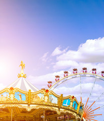 Carousel and ferris wheel in the park. Summer fun for the whole family. Good rest. Extreme. Sun...
