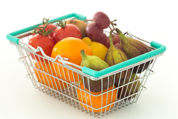 Shopping basked with fruits and vegetables on a white backgrounds / concept healthy, nutrition supporting the diet