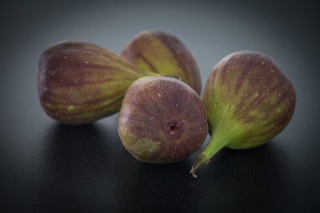 Figs fruits on the dark stone background