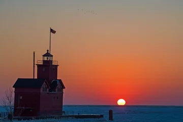 Wall murals Lighthouse Michigan red lighthouse on Lake Michigan pier in winter at sunset time