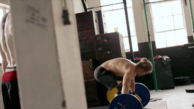 Strong man weightlifting in cross fit gym

