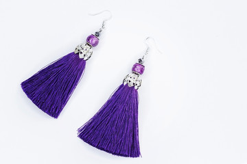 Purple handmade earrings on white