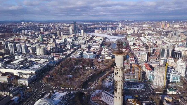Aerial view on abandoned TV tower in Yekaterinburg. Clip. Aerial view of abandoned, old building, TV tover or communication tower with city landscape background
