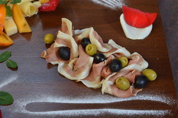 Salad of cold cuts with olive, salami, parma ham and cheeses