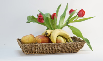 ripe bio apples and bananas and tulips