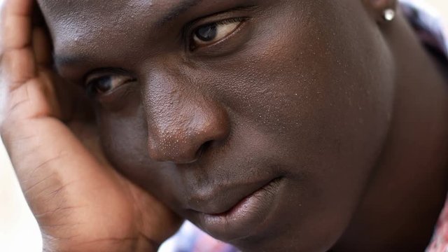 Close up on pensive daydreaming young black african man