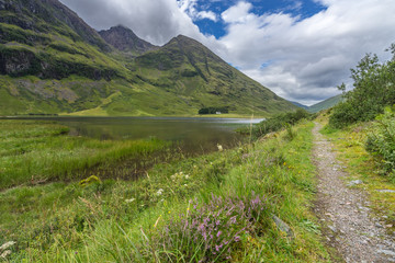 A scenic trail on the banks of Loch Achtriochtan in Glencoe valley, Highlands, Scotland, Britain