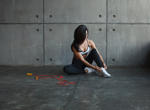 fit  woman tie shoelaces before workout