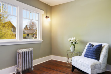 Green bedroom nook with an accent armless chair